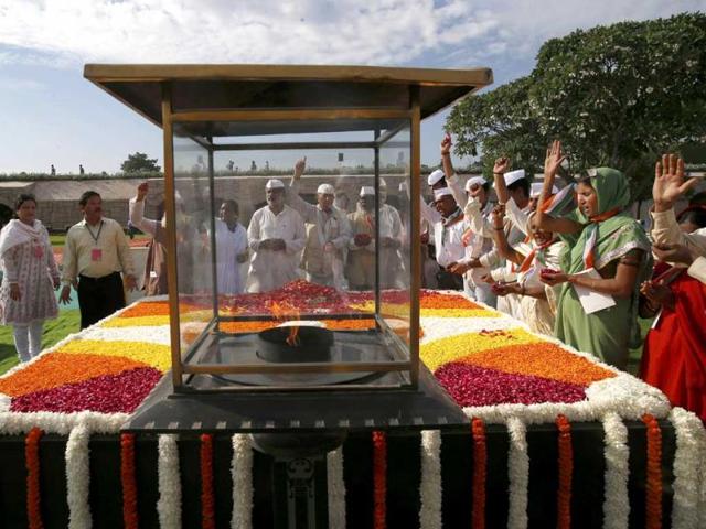 People offer their prayers at a memorial of Mahatma Gandhi on the occasion of his birth anniversary, in New Delhi. (AP Photo)