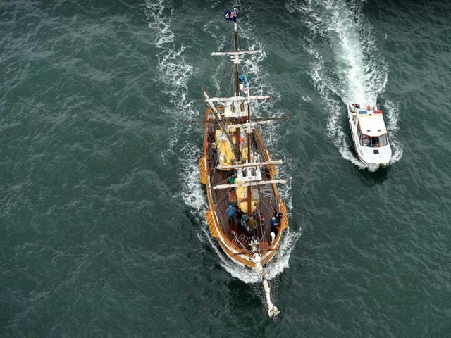 A tall ship sails under the Sydney harbour bridge on the eve of the International Fleet Review. (AFP Photo)