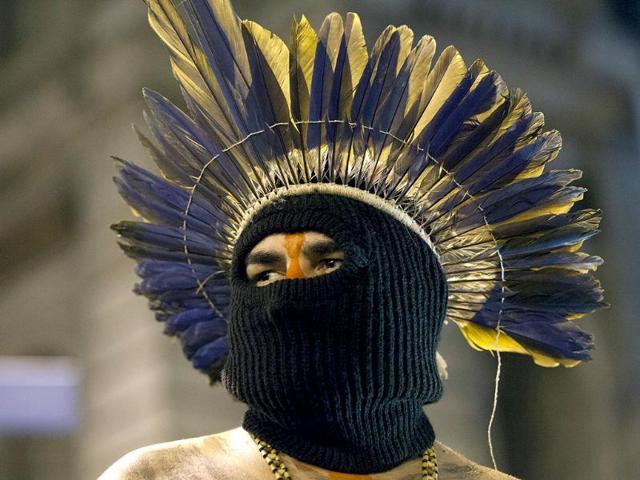 An indigenous man wears a mask during a march in support of teachers on strike in Rio de Janeiro, Brazil. (AP Photo)