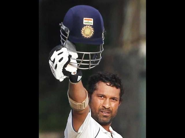 Sachin Tendulkar raises his helmet to celebrate after scoring his century against Sri Lanka during the third day of their second test cricket match in Colombo in 2009. (Reuters Photo)