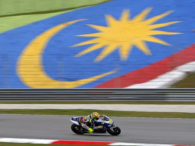 MotoGP rider Valentino Rossi of Italy steers his Yamaha during the first free practice session for Malaysian Motorcycle Grand Prix in Sepang, Malaysia. (AP Photo)