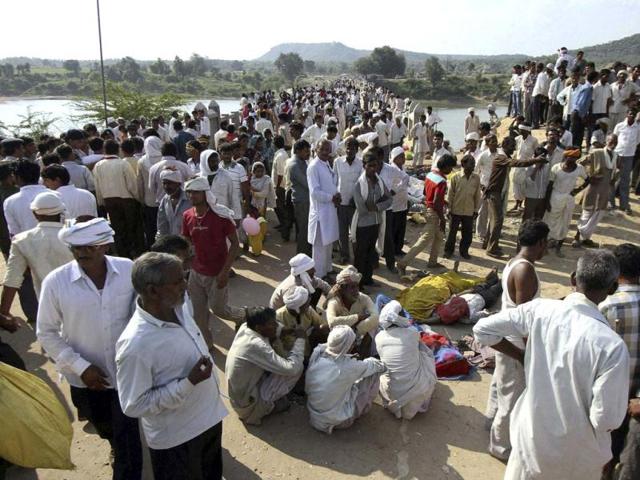 Villagers gather after a deadly stampede on a bridge across the Sindh River in Datia district in Madhya Pradesh state. (AP Photo)