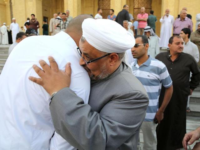 Iraqis exchange greetings after prayers at the 17th Ramadan mosque on the first day of Eid al-Adha in Baghdad. (AP photo)