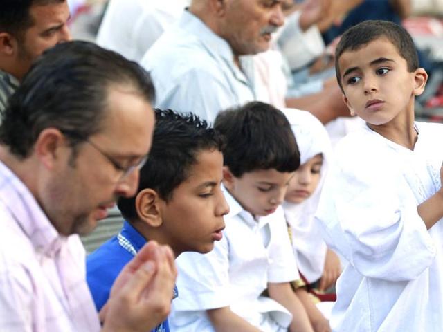 A boy prays during Eid al-Adha in Tunis to mark the end of the haj pilgrimage by slaughtering animals to commemorate Prophet Abraham's willingness to sacrifice his son, Ismail, on God's command. (Reuters photo)
