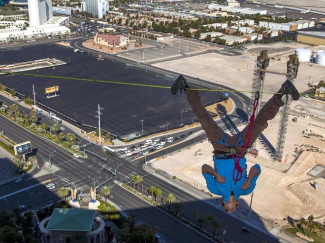 Slackliner Hayden Nickell performs a trick on an urban highline outside the 63rd floor of at the Mandalay Bay Resort in Las Vegas, Nevada. The stunt was held to kick off the World Slackline Federation World Cup Finals.(Reuters photo)