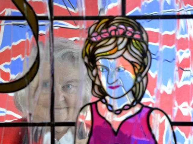 Margaret Tyler looks through a stained glass window depicting Princess Diana at her home, which she has dedicated as a shrine to the British royal family. (Reuters Photo)