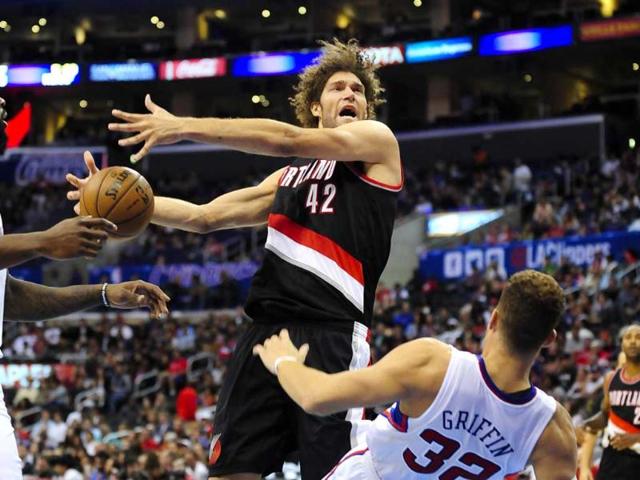 Portland Trail Blazers center Robin Lopez collides with Los Angeles Clippers forward Blake Griffin as he drives to the basket in the first half of a pre-season NBA basketball game in LA.(AP Photo)