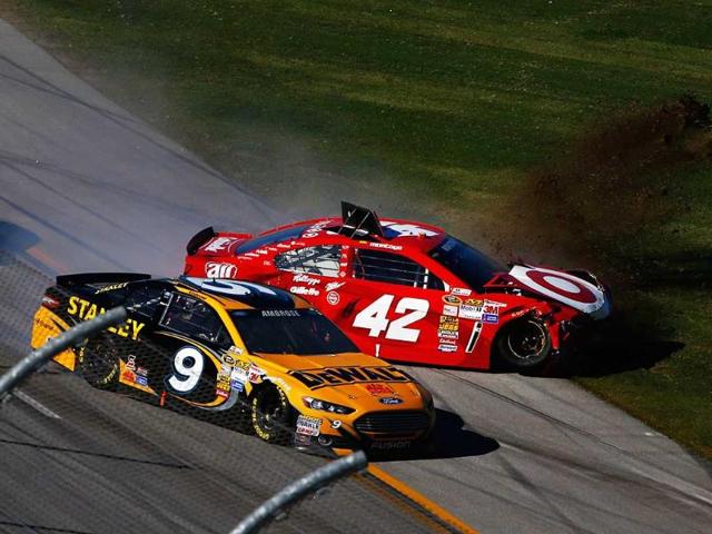 Marcos Ambrose, driver of the #9 DeWalt Ford, and Juan Pablo Montoya, driver of the #42 Target Chevrolet, are involved in an incident during the NASCAR Sprint Cup Series Camping World RV Sales 500 in Talladega, Alabama. (AFP Photo)