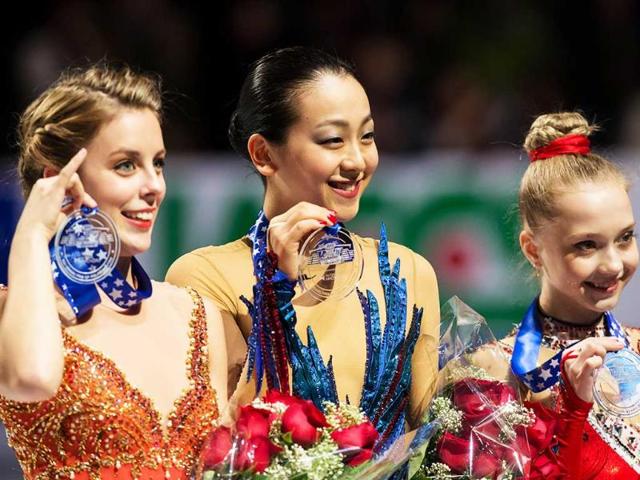 Gold medalist Mao Asada of Japan, silver medalist Ashley Wagner of the US and bronze medalist Elena Radionova of Russia pose with their medals during the women's medal ceremony at Skate America 2013 in Detroit, Michigan. (AFP Photo)