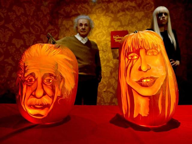 Pumpkins representing US singer Lady Gaga and scientist Albert Einstein on display in front of their wax figures at Madame Tussauds ahead of Halloween in New York. (AFP Photo)