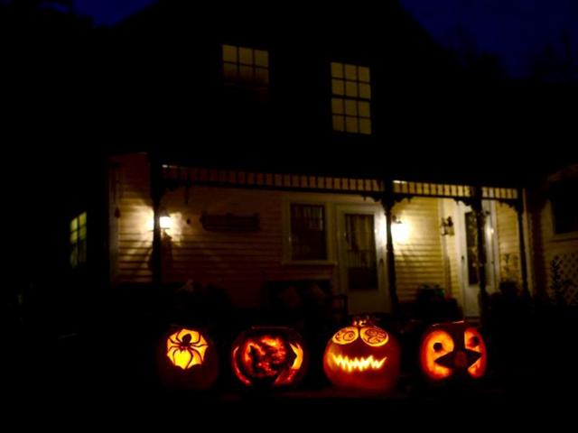 Carved pumpkins lit in front of a house in Montague, Massachusetts ahead of Halloween. (AFP Photo)
