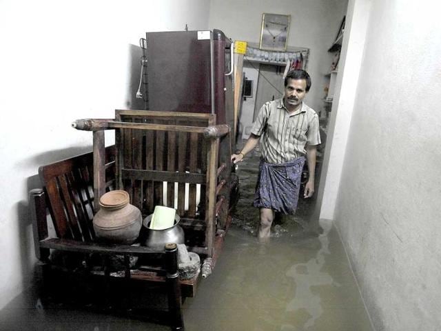A resident walks through a flooded house following heavy rain in Saroornagar, a low lying area on the outskirts of Hyderabad. (AFP photo)