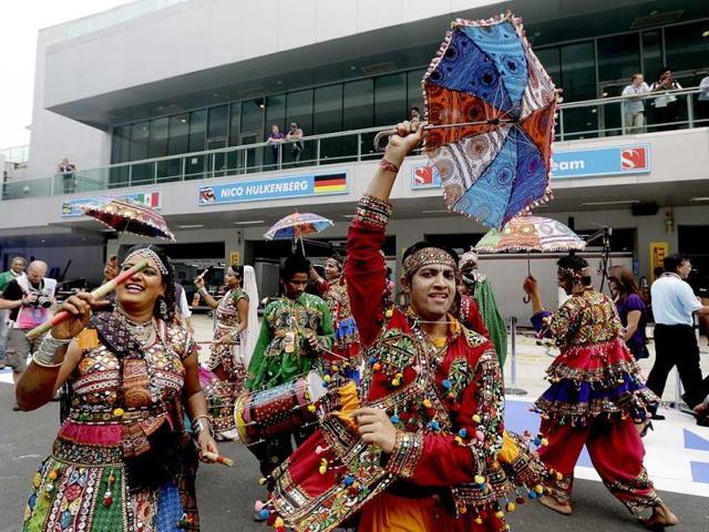 A group of traditional Indian dancers perform in pit lane prior to the start of the Indian Formula One Grand Prix at the Buddh International Circuit in Noida. (AP Photo)