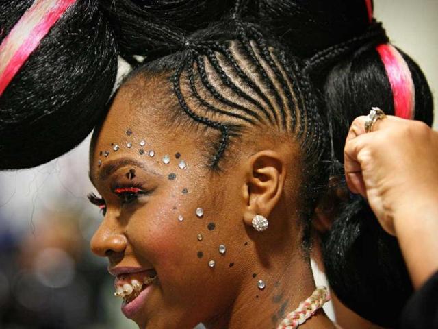 Chaelah Morris, of Tampa, pauses as her hair is adjusted at the Mane Stream Hair and Beauty Expo at the Tampa Convention Center in Tampa. (AP Photo)