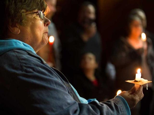 Hamilton Resident Joan Ford attends a candlelight vigil at the West Hamilton Beach Volunteer Fire Department to commemorate the one-year anniversary of Superstorm Sandy in the Queens borough of New York. (AP Photo)