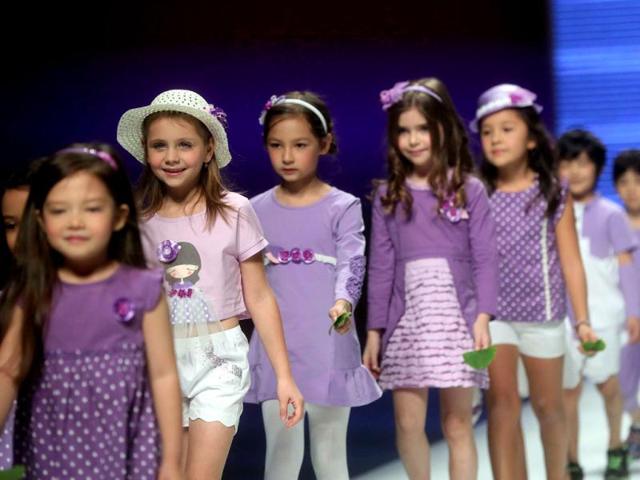 Young models parade creations from the 1001 Nights Yeye Children's Collection during China Fashion Week in Beijing. (AFP photo)