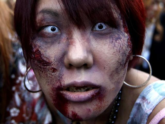 A participant dressed as a zombie marches during a Halloween event to promote the US TV series 'The Walking Dead' at Tokyo Tower. Reuters/Issei Kato
