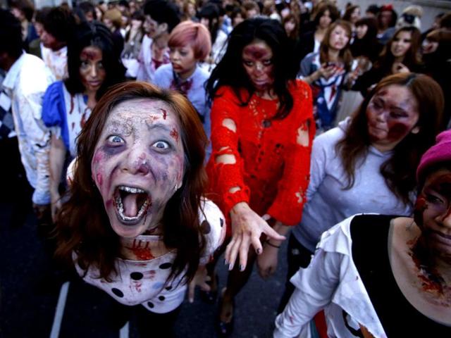 Participants wearing costumes and make-up as zombies march during a Halloween event to promote the US TV series "The Walking Dead" at Tokyo Tower. Reuters/Issei Kato