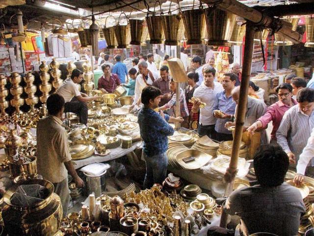 People buy metal pots on the occasion of Dhanteras festival in Patna. (PTI Photo)