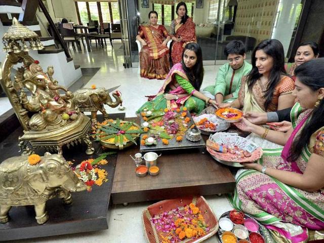 Women perform Ganesh puja on the occasion of Dhanteras festival in Ahmedabad. (PTI Photo)