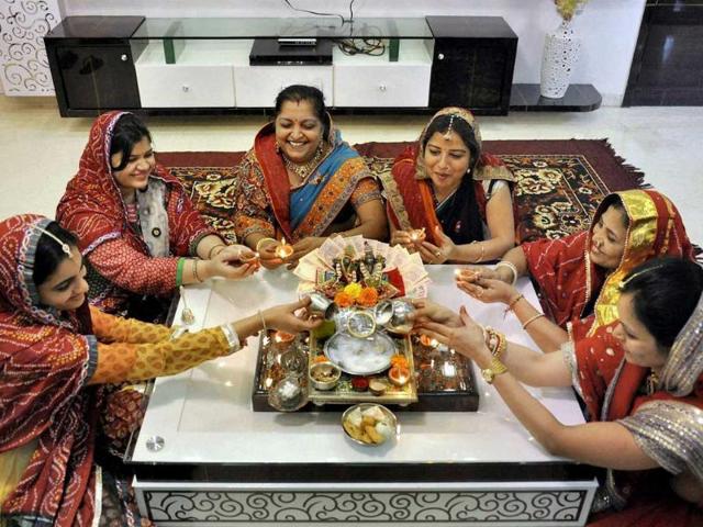 Housewives perform Laxmi puja on the occasion of Dhanteras in Surat. (PTI Photo)