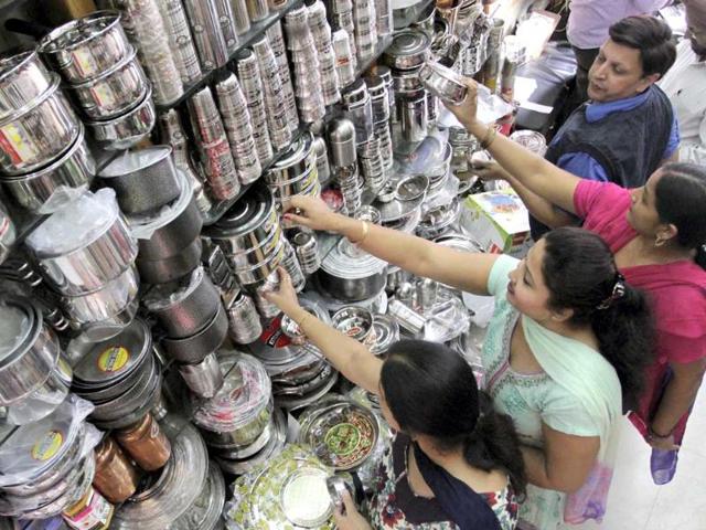 Women buy utensils at a market on the occasion of Dhanteras festival in Jammu. (PTI Photo)