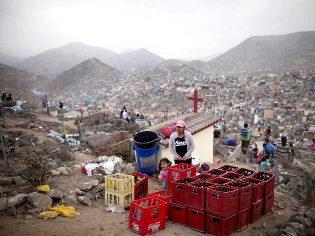 Boxes containing beer bottles are seen next to graves at the Nueva Esperanza cemetery during Day of the Dead celebrations in Villa Maria, Lima. Each year people visit the cemetery, one of Latin America's largest, to honour the dead. (Reuters)