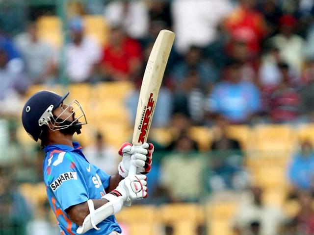 Shikhar Dhawan plays a shot during the 7th ODI against Australia at the Chinnaswamy stadium in Bangalore. (PTI Photo)