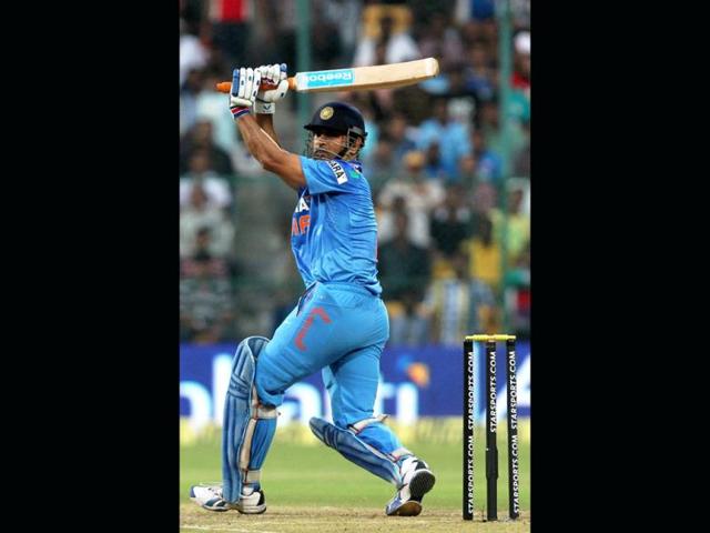 Captain MS Dhoni plays a shot in the 7th ODI against Australia at the Chinnaswamy stadium in Bangalore. (PTI Photo)