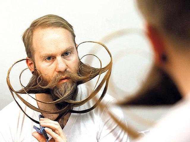 Participant Justin Kellermeier of the US styles his beard for the Beard World Championship 2013 in Leinfelden-Echterdingen, Germany. (Reuters Photo)