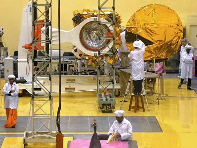 In this photograph taken on September 11, scientists and engineers work on a Mars Orbiter vehicle at the Indian Space Research Organisation's satellite centre in Bangalore. (AFP Photo)