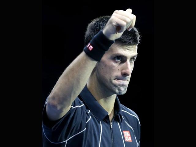 Novak Djokovic of Serbia celebrates at match point after winning against Roger Federer of Switzerland during their ATP World Tour Finals tennis match at the O2 Arena in London. (AP Photo)