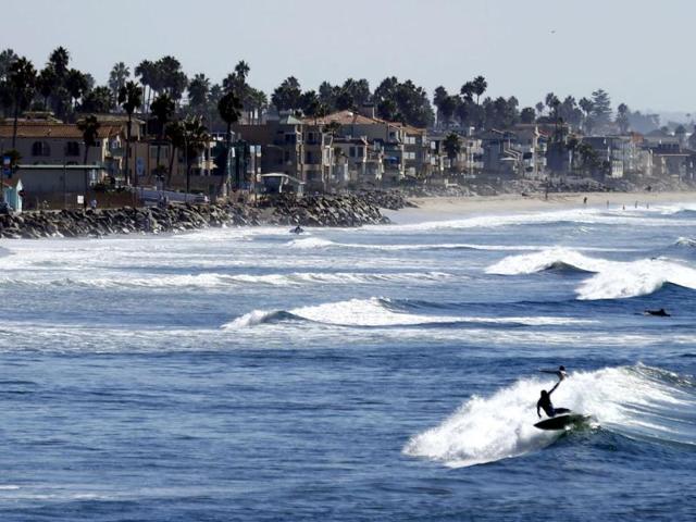 A surfer catches a wave off the coast of Oceanside, California. (Reuters)