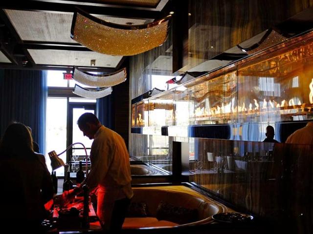 A chef carves a Prime Dry-Aged Porterhouse steak in the 630 Park Steakhouse at the Graton Resort and Casino in Rohnert Park, California. (AP Photo)