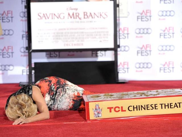 Actress Emma Thompson is honored with a hand and footprint ceremony at the TCL Chinese Theatre in Los Angeles. Thompson jokingly lays down on the carpet during the ceremony pausing for a few seconds. She co-stars with Tom Hanks in the upcoming film, "Saving Mr. Banks." (AP photo)