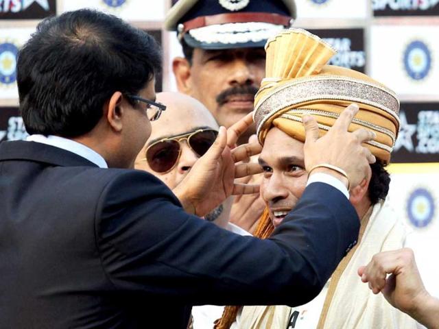 Former captain Sourav Ganguly honours master blaster Sachin Tendulkar at the presentation ceremony after the end of the first Test match against West Indies at Eden Garden in Kolkata. (PTI Photo)