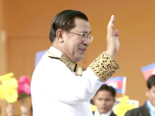 Cambodian Prime Minister Hun Sen greets well-wishers during an Independence Day in front of Royal Palace, in Phnom Penh, Cambodia. Hun Sen attended the celebration to mark the country's 60th Independence Day from France. (AP Photo)