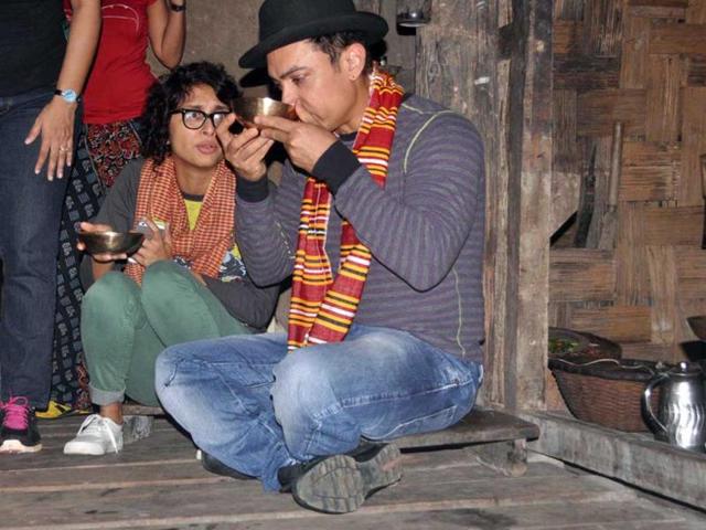 Aamir Khan and Kiran Rao were spotted in Assam recently. The couple was there to celebrate Kiran's 40th birthday. In the image, they sip a tribal rice brew of Assam, locally known as ‘apong’, sitting on a bamboo house-on-stilts in a village in Assam. Browse through for more
