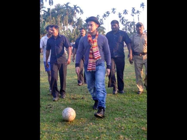 An enthusiastic Aamir trying his hand on a football session in Assam