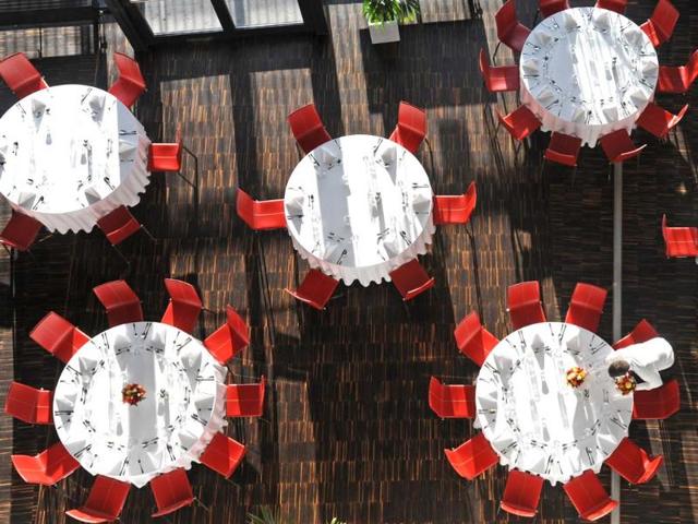 A waiter places flowers on a table in one of the conference restaurants on the first day of the United Nations Climate Change Conference in Warsaw, Poland. (AP Photo)