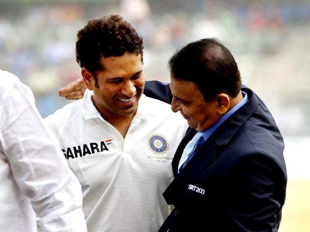 Legendary cricketer Sunil Gavaskar greets Sachin Tendulkar during the release of the postal stamp honouring the latter on his last Test match against West Indies at Wankhede Stadium in Mumbai. (Ajay Aggarwal/ HT photo)