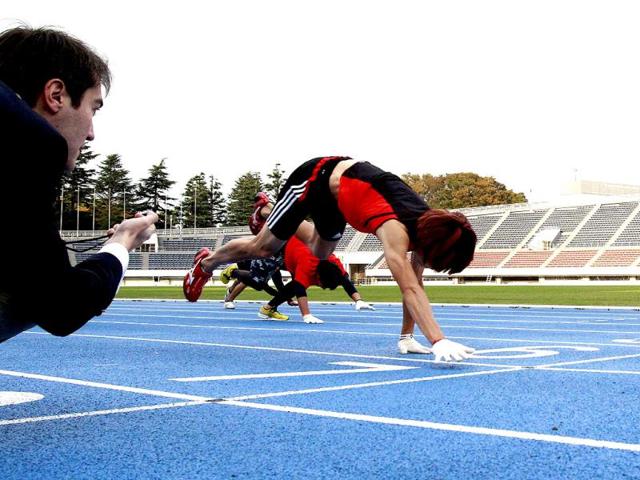 Kenichi Ito (2nd L), known as the "world's fastest man on four legs", reaches the finishing line as an official clocks his time during a four-legged 100-metre race organized by himself in Tokyo. The 31-year-old, who developed his skills over 10 years based on the running style of the African Patas monkey, set a new Guinness World Record on Thursday, clocking in 16:87 seconds for a 100-metre run and breaking his previous record of 17:23 seconds, according to media reports. (Reuters)
