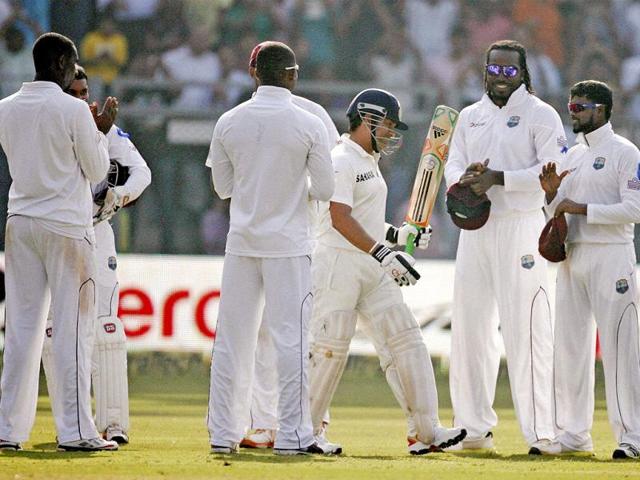 West Indian players clap to pay their respect to Sachin Tendulkar as he arrives to bat on Day 1 of their 2nd test match at Wankhede Stadium in Mumbai. (PTI/Shashank Parade)