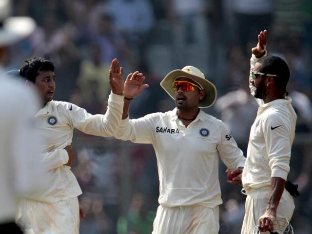 Pragyan Ojha celebrates the wicket of West Indies batsman Tino Best during the 2nd Test match between India and the West Indies at the Wankhede Stadium in Mumbai. (HT Photo/Satish Bate)