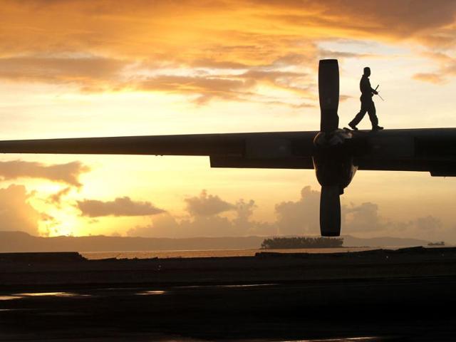 A Philippine air crew member does pre-flight checks on a C-130 evacuation flight at the airport in Tacloban, central Philippines. (AP Photo)