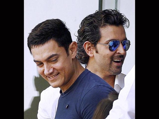 We catch Hrithik Roshan and Aamir Khan, wearing his lucky blue shirt, at Wankhede Stadium on Friday where Tendulkar is playing his last match.