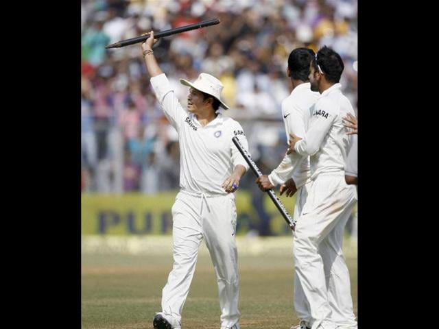 Sachin Tendulkar carries a stump as he walks out of the ground after India beat West Indies at Wankhede in Mumbai. (PTI Photo)