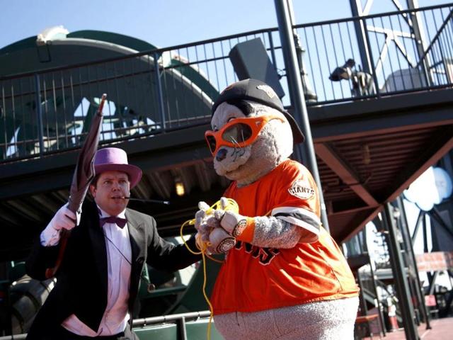 The Penguin holds the San Francisco Giants mascot Lou Seal captive as they wait for the arrival of Batkid. Miles lives in Tulelake in northern California.