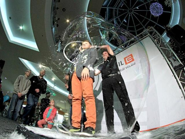 A boy speaks on the telephone from inside a giant bubble made by professional bubblemaker Matej Kodes (R) during the Guinness Book of records attempt to set a new record in Olomouc, Czech Republic. (AFP photo)