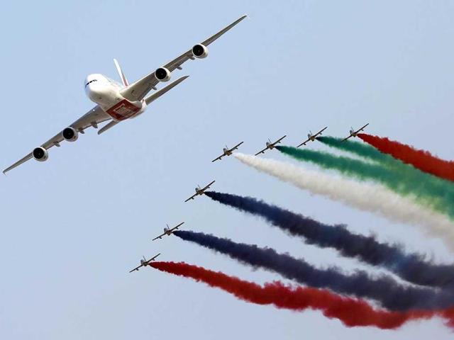 United Arab Emirates' Air Force Aerobatic Team, Al-Fursan, performs with an Emirates Airline's Airbus A380 (L) at the Dubai Airshow in Dubai. (AFP Photo)
